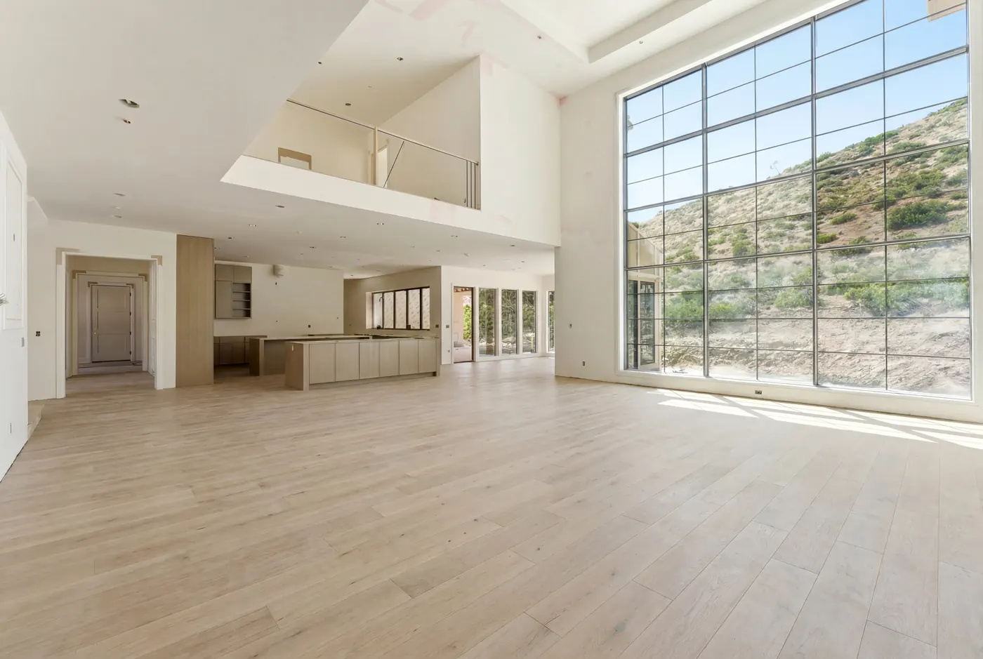The great room open to the kitchen with a wall of windows